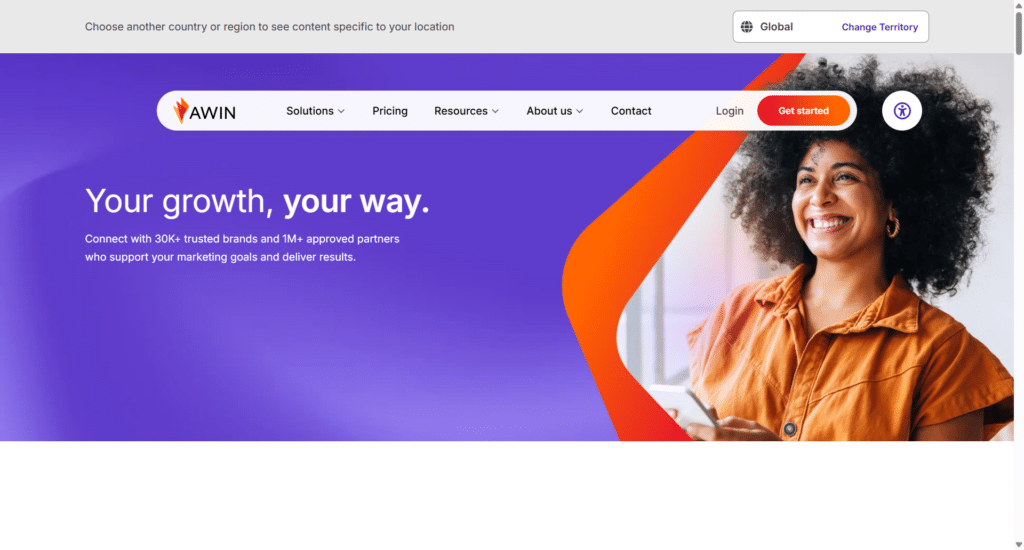 Awin affiliate marketing network homepage featuring the headline Your growth, your way alongside a smiling woman holding a smartphone.