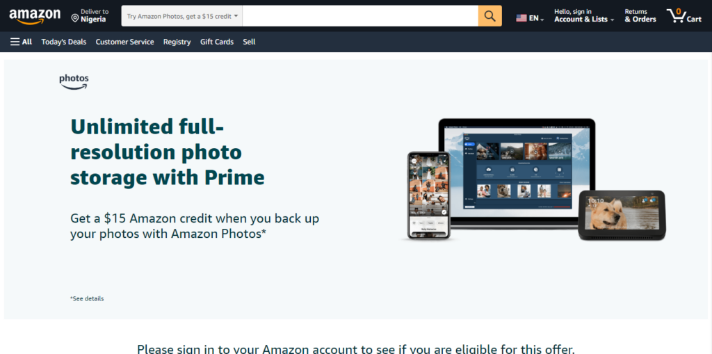 Amazon com Try Amazon Photos get a 15 credit - CyberNaira A professional screenshot of an Amazon.com promotional page titled "Unlimited full-resolution photo storage with Prime." The header features the Amazon logo and a delivery location set to Nigeria. The central message offers a "$15 Amazon credit" for backing up photos with Amazon Photos. To the right, high-quality graphics display the interface across a smartphone, a laptop, and an Echo Show device, illustrating cross-platform synchronization. A search bar at the top suggests users can "Try Amazon Photos" to claim the credit, and the footer prompts users to sign in to check eligibility.
