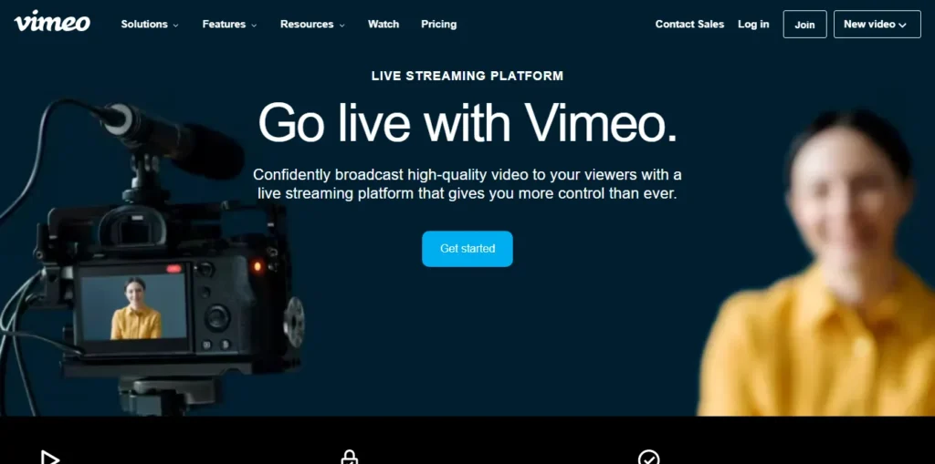 Vimeo live streaming platform homepage showing the headline “Go live with Vimeo” and a camera recording a presenter.