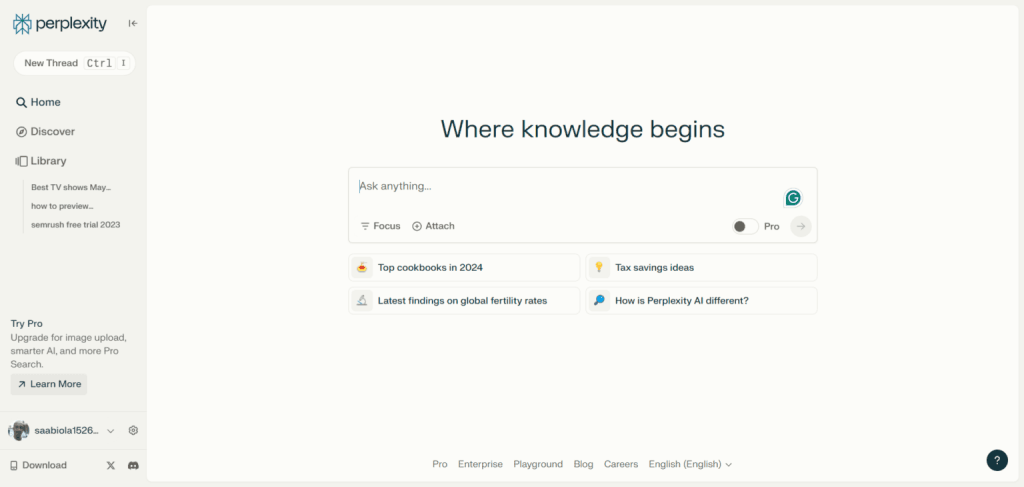 Perplexity AI answer engine homepage with a central search bar, and suggested prompts like "Top cookbooks in 2024."